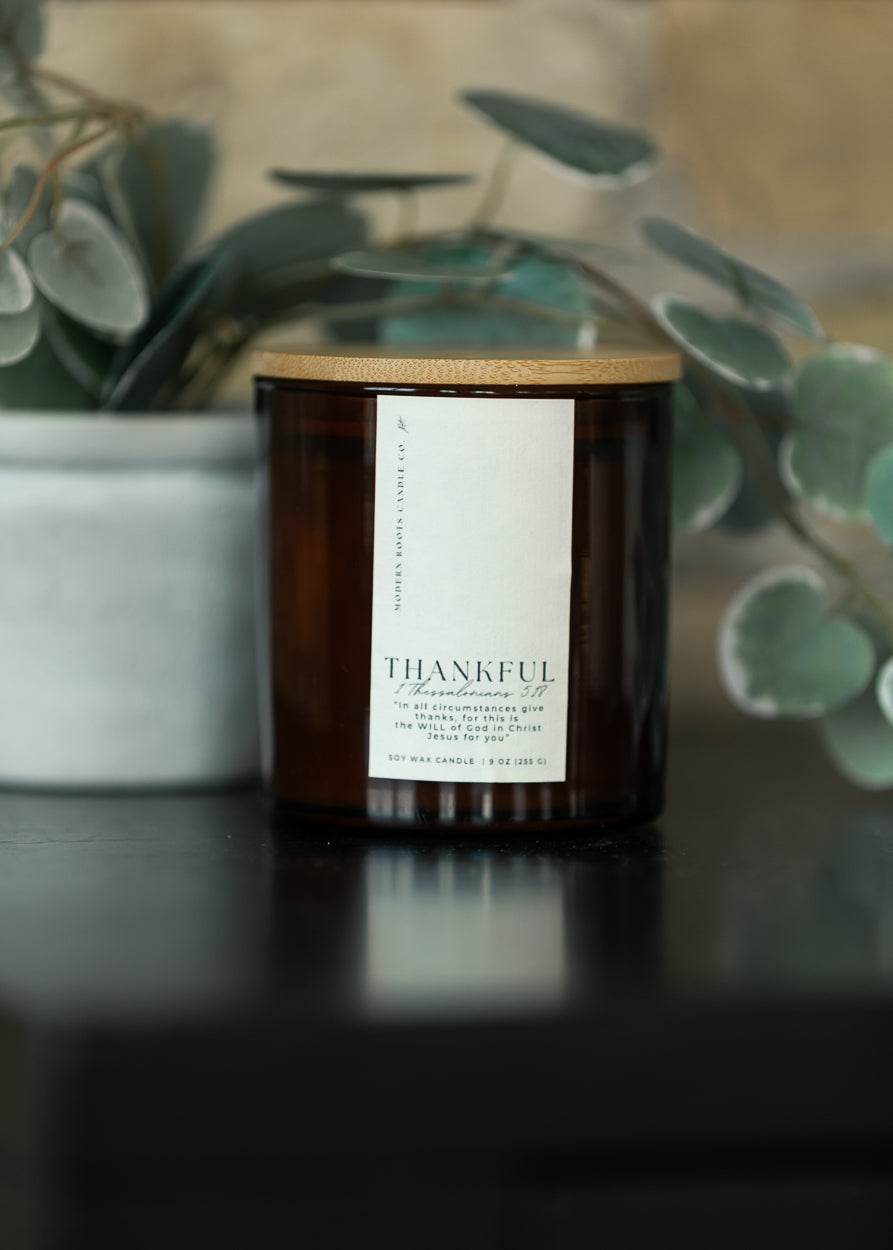 Thankful Pumpkin Spice and Vanilla 9 oz. natural soy candle in an amber glass jar with wood lid.