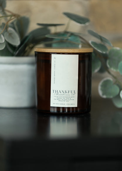 Thankful Pumpkin Spice and Vanilla 9 oz. natural soy candle in an amber glass jar with wood lid.