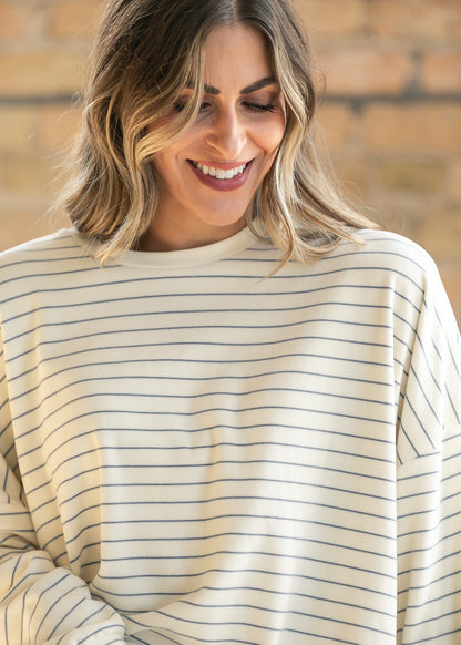 Close-up of ivory striped Ashton top showing the crew neckline, drop shoulders, and relaxed fit.