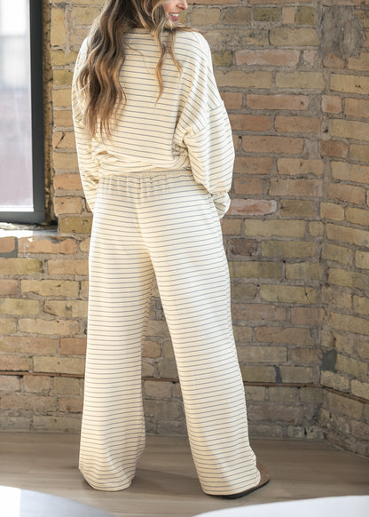 Back of ivory striped wide leg pants showing the relaxed silhouette and fully elastic waistband.