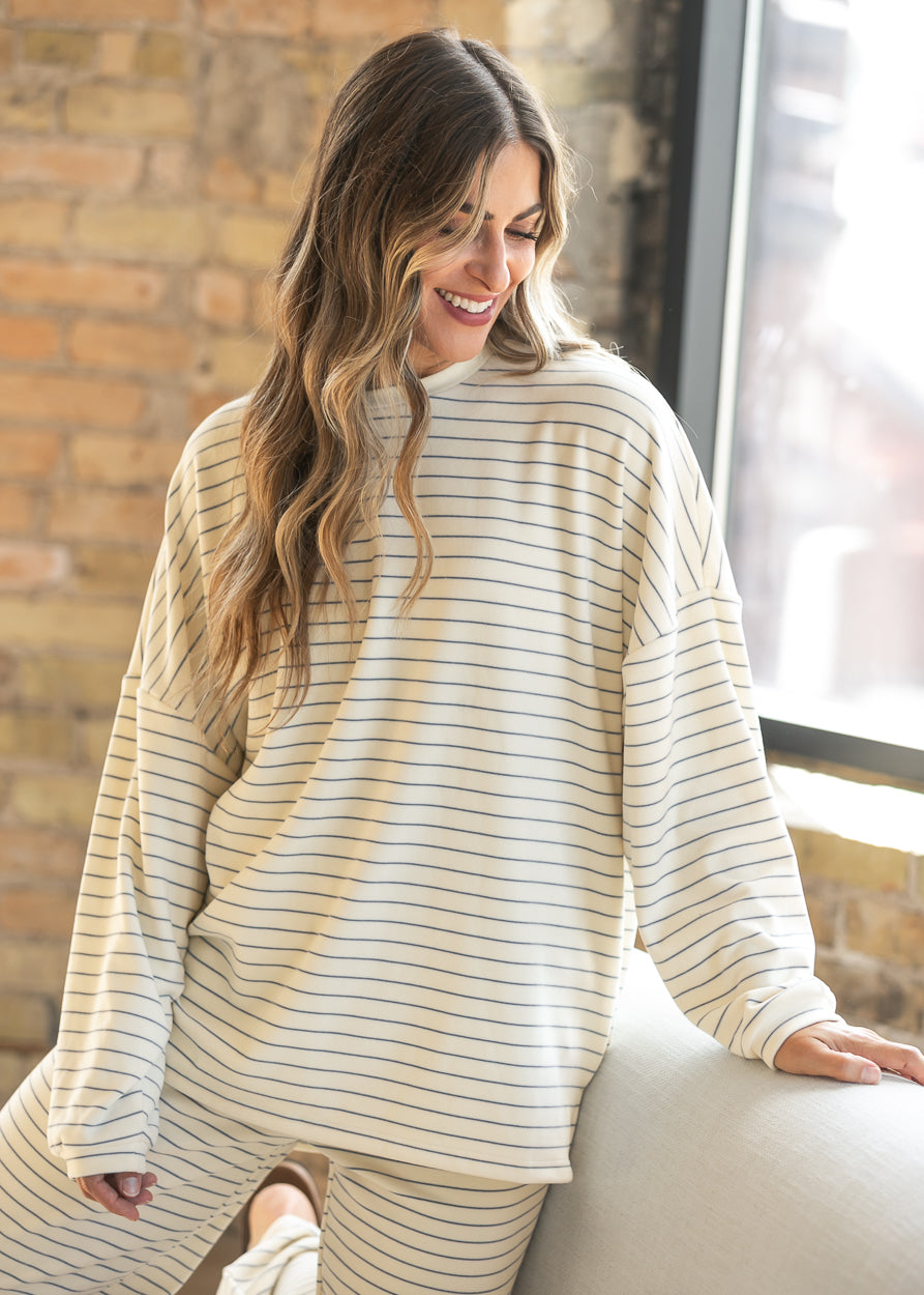 Ivory striped oversized long sleeve top with matching wide leg pants, showing the soft stretch fabric.