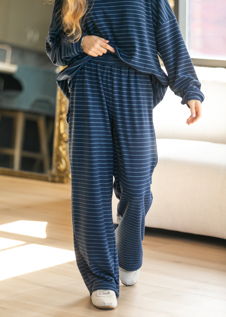 Navy striped wide leg pants with a loose floor-length fit and fully elastic waistband.
