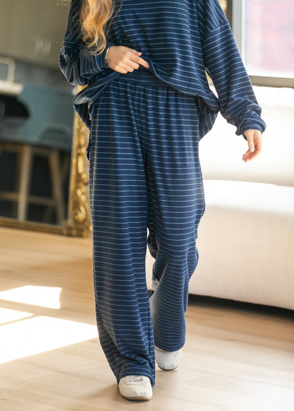 Navy striped wide leg pants with a loose floor-length fit and fully elastic waistband.