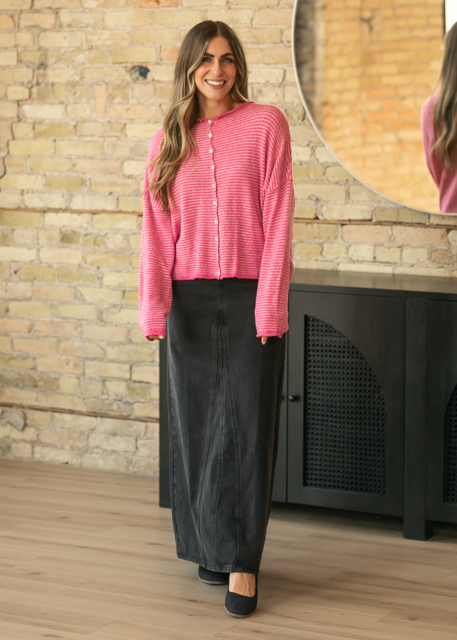 Full-length styling of bubblegum pink Piper Cardigan with black denim maxi skirt and flats.