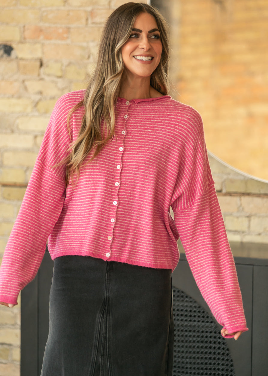 Bubblegum pink striped button-front cardigan styled with a black denim maxi skirt.