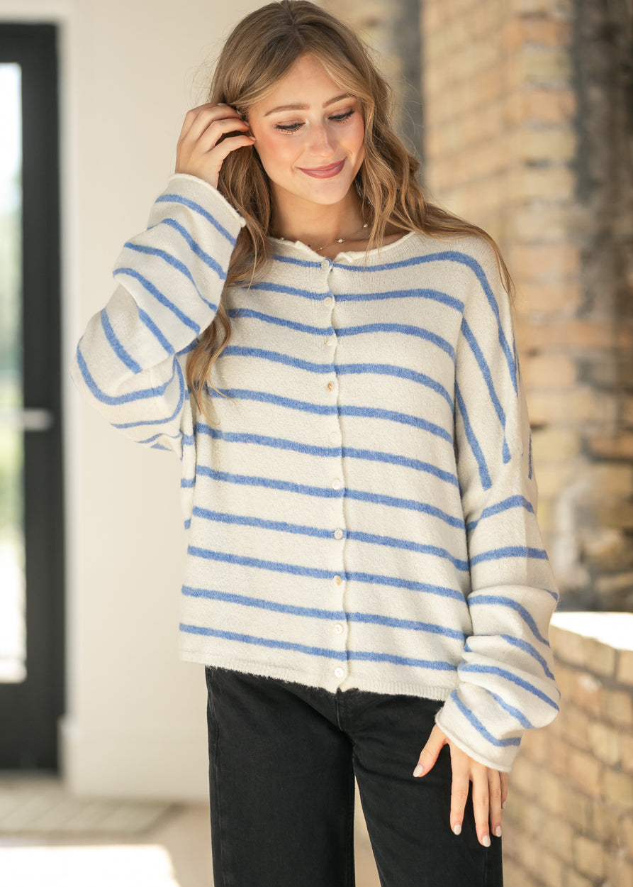 Close-up of the ivory and blue striped Piper cardigan showing the button-front closure and crew neckline.