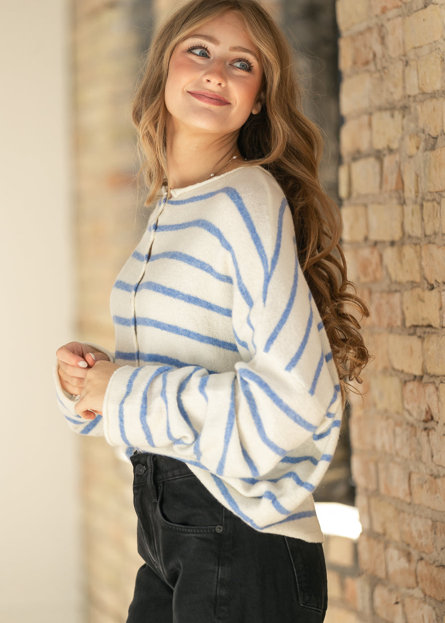 Ivory and blue striped Piper cardigan styled with a delicate necklace and soft waves.