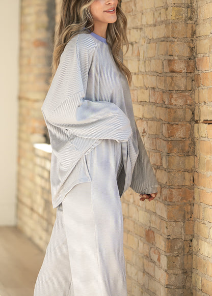 Side view of Kenzie striped top showing the soft drape, long sleeves, and oversized silhouette.