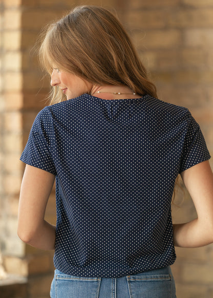 Back of navy polka dot jersey short sleeve tee showing the loose hip-length fit and allover print.