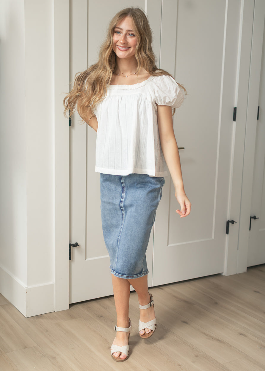 Close-up of white swiss dot cotton top with gathered neckline detail