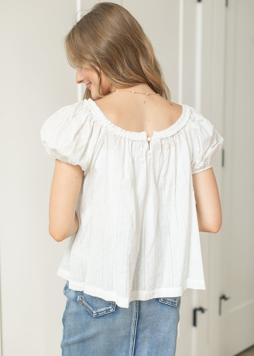 Things Between white blouse featuring a ruffle neckline and airy silhouette