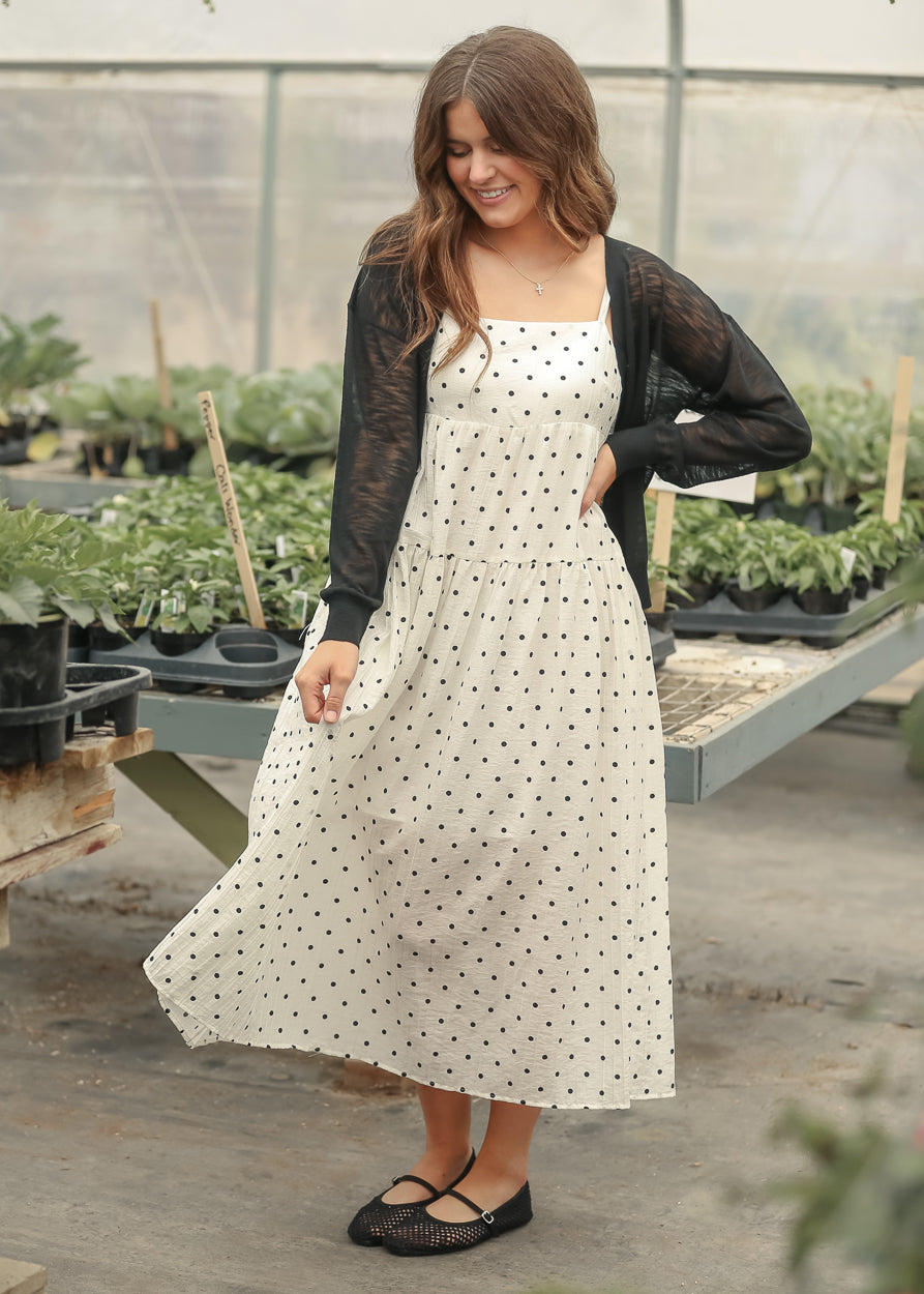 Black button front cardigan with ribbed hem and lightweight sheer sleeves