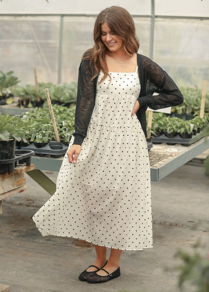 Black button front cardigan with ribbed hem and lightweight sheer sleeves