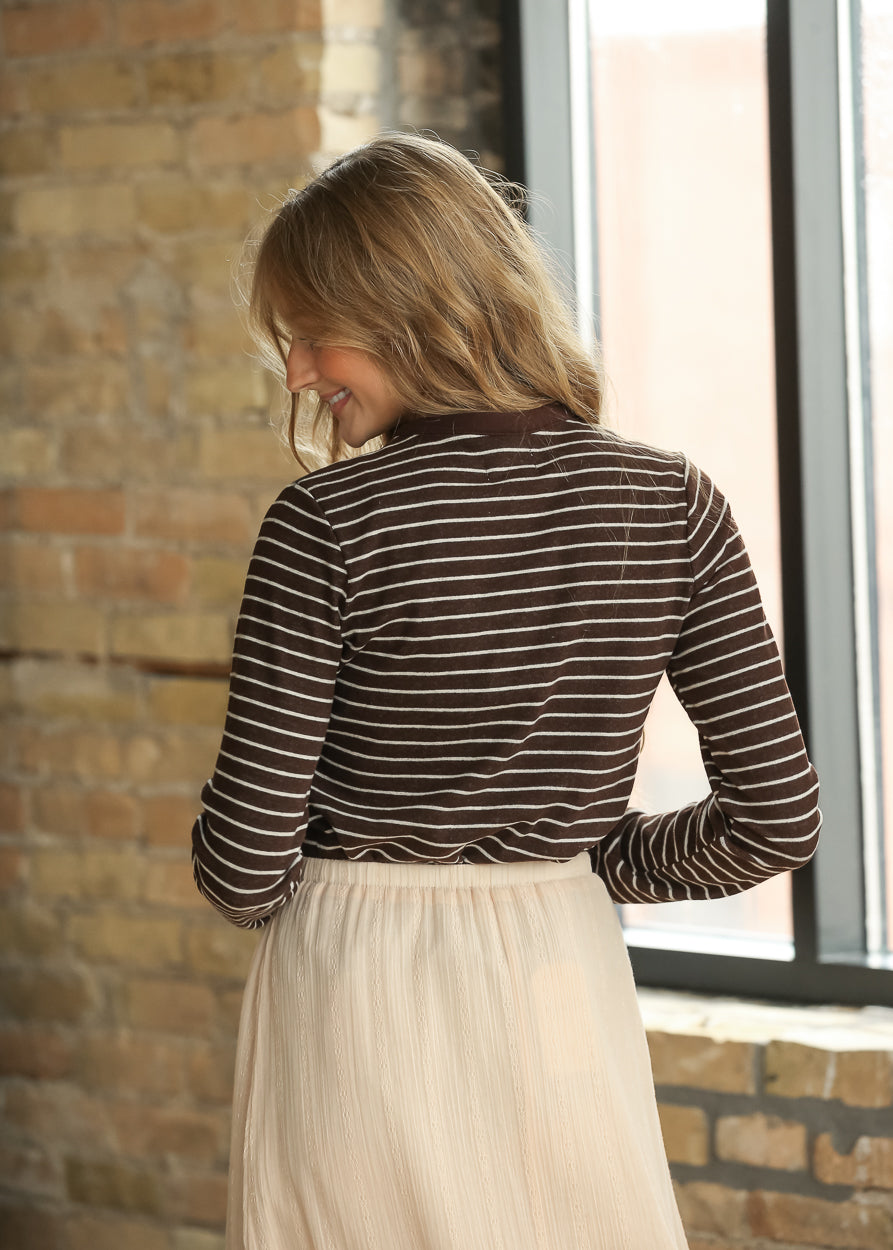 Back view of brown and cream striped long sleeve top with relaxed fit.