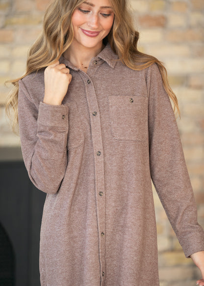 Close-up of Clove Heather Leslie dress with pointed collar, button front, cuff buttons, and chest pockets.