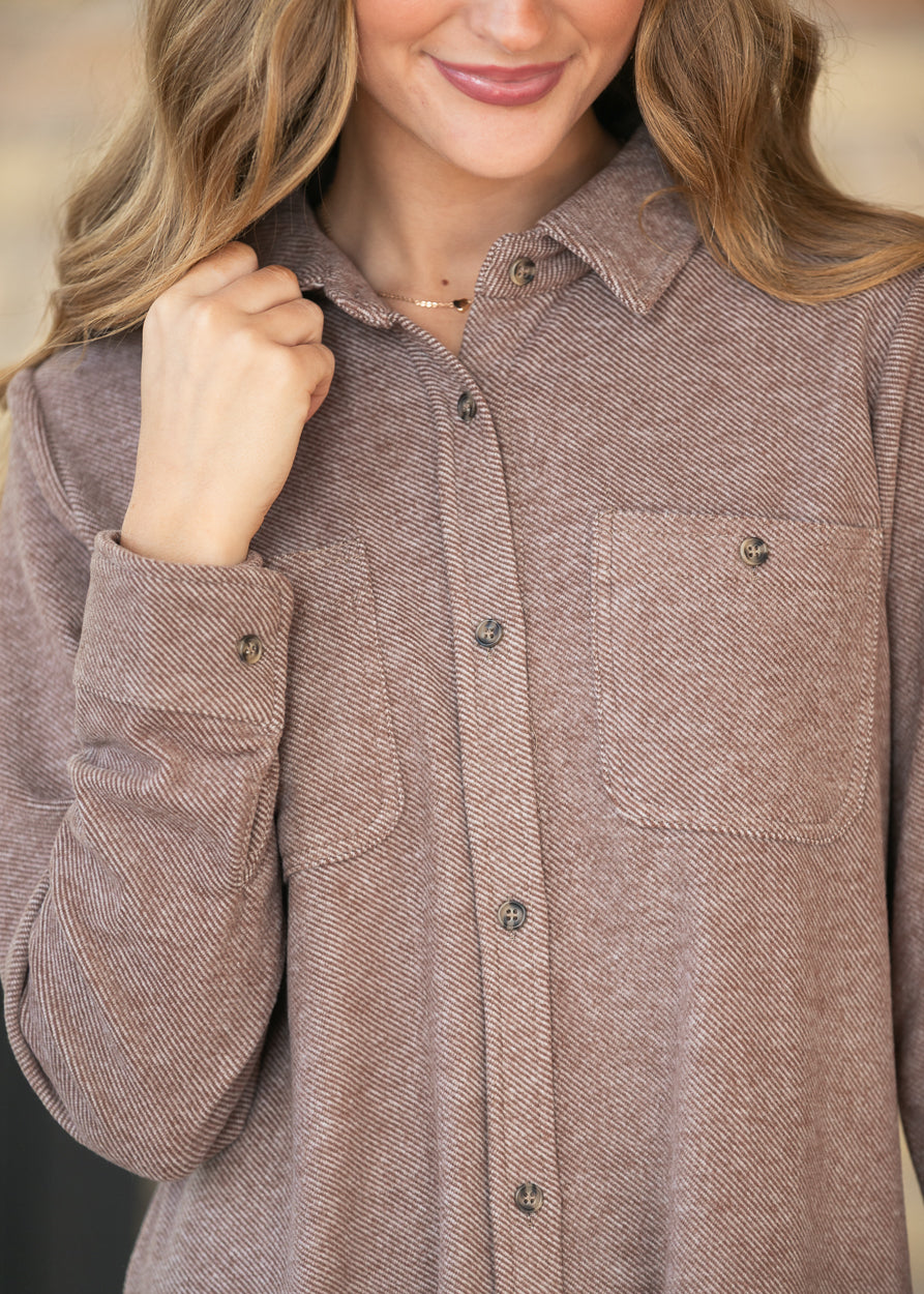 Close-up of Clove Heather Leslie dress with pointed collar, button front, cuff buttons, and chest pockets.