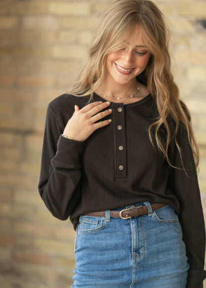 Espresso long sleeve henley top with relaxed fit and functional button placket, styled with denim.