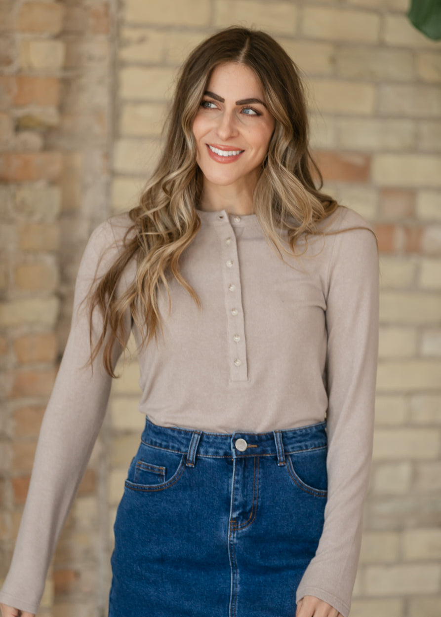 Heather taupe long sleeve Henley top tucked into a dark wash denim skirt, showing the loose silhouette.