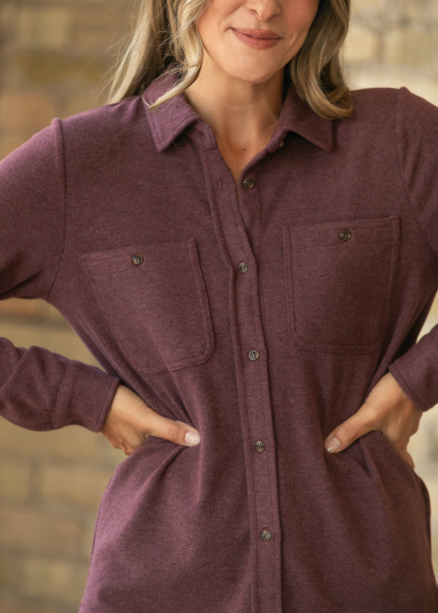 Burgundy button up long sleeve top with collared neckline, button front, and two chest pockets.