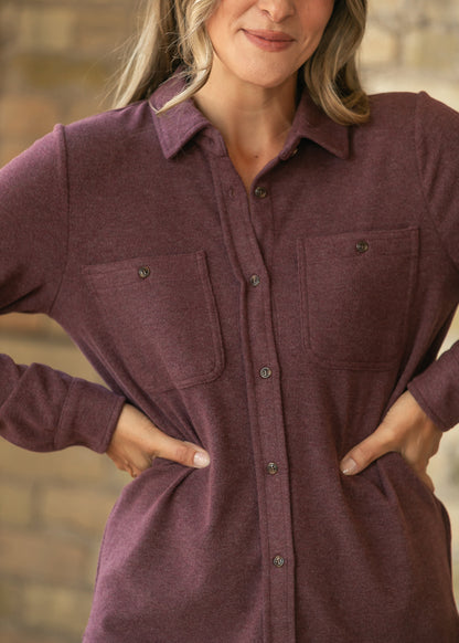 Burgundy button up long sleeve top with collared neckline, button front, and two chest pockets.