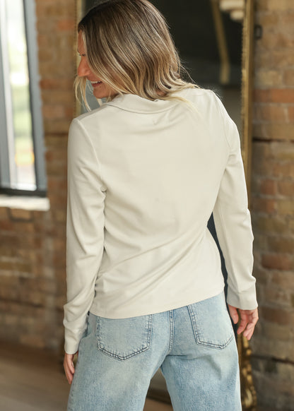 Back view of cream long sleeve button-up shirt showing smooth stretch fabric and hip-length fit.