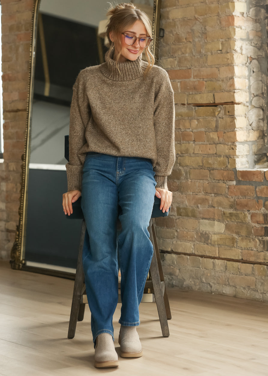Sandstone Classic Knit Sweater styled with blue jeans and neutral ankle boots.