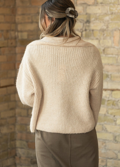 Back of oatmeal rib-knit long sleeve jacket showing the loose hip-length silhouette.