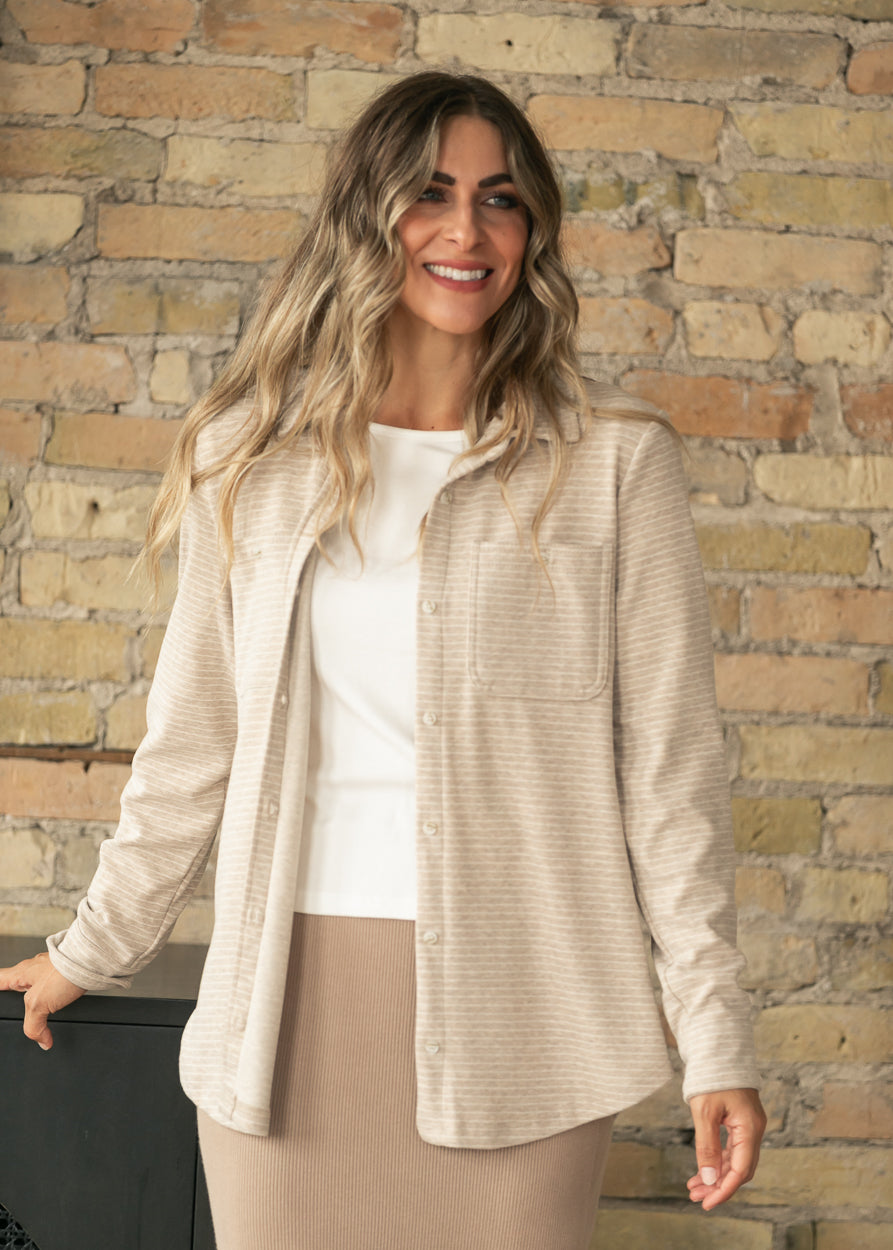 Tan striped Lewis shirt worn open over a white tee and tan knit midi skirt, styled with brown mary jane flats.