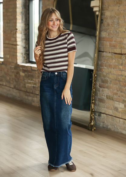 Model wearing maroon stripe Welles knit top with dark wash denim maxi skirt.