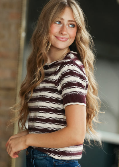 Side of maroon and cream striped Welles knit top with short sleeves and textured stitch detail.