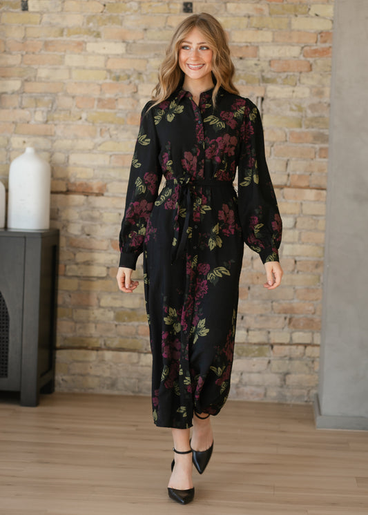 Black and burgundy floral midi dress featuring a button front, matching waist tie, and gathered sleeve cuffs.