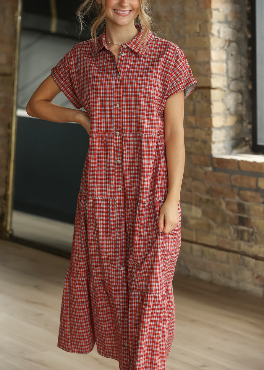 Close-up of red gingham dress showing the collared neckline and functional front buttons.