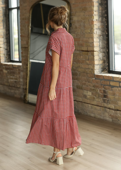 Back of red gingham tiered midi dress showing the collared neckline, short sleeves, and full skirt.