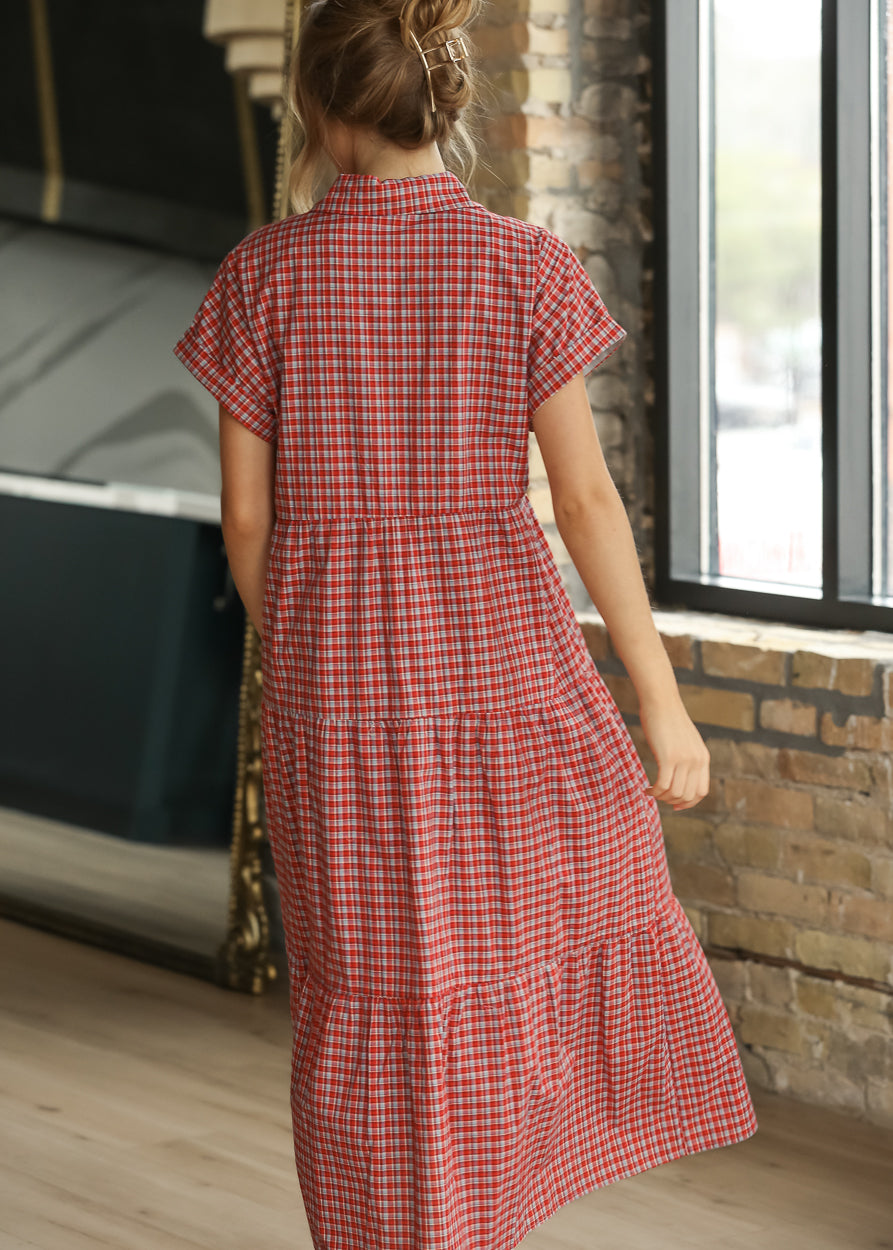 Red gingham cotton midi dress with short sleeves, button front, and gathered tiered construction.