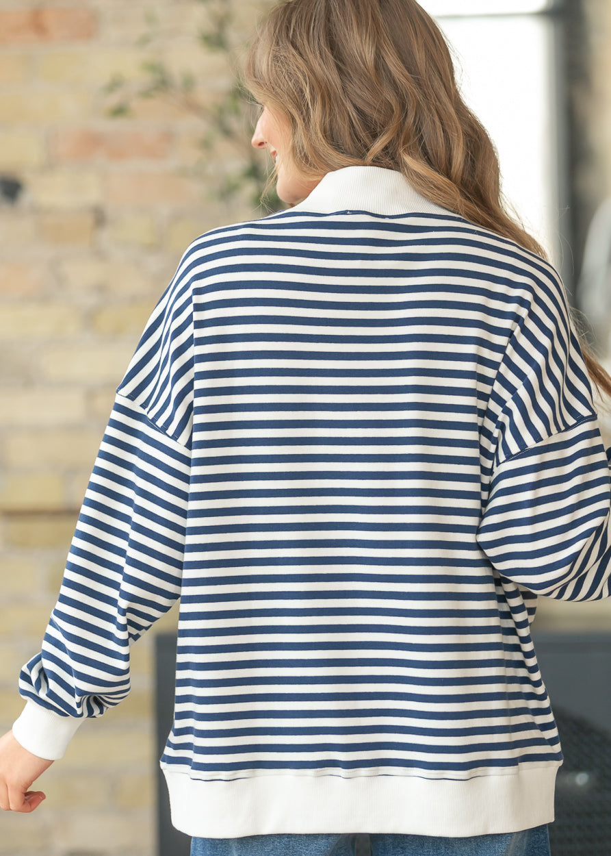 USA mockneck sweatshirt styled with wide leg jeans and white sneakers