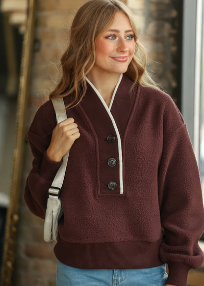 Varley Brenna Mahogany fleece pullover with functional button neckline and ribbed contrast trim.