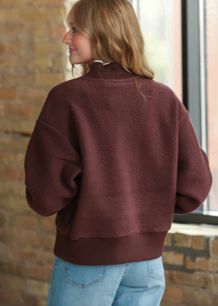 Back view of Varley Brenna Mahogany fleece pullover showing oversized fit and ribbed hem.