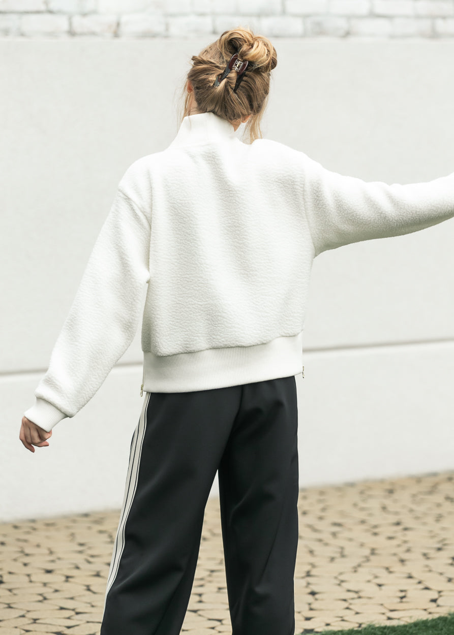 Back view of cream textured fleece with ribbed collar and hem