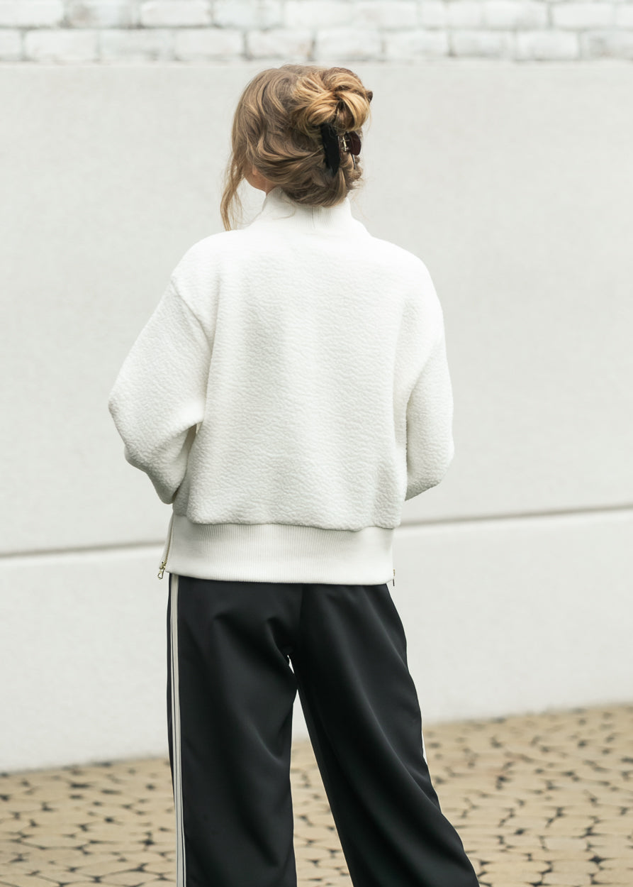 Back view of cream Varley Mumford fleece with hip-length fit