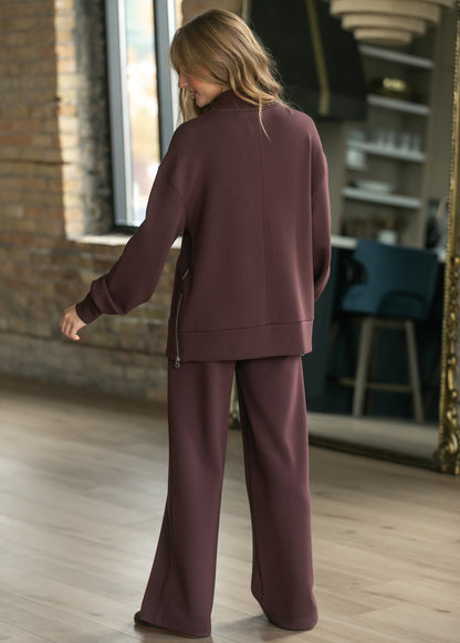 Chocolate brown Varley Novi longline sweatshirt styled with coordinating wide leg pants.