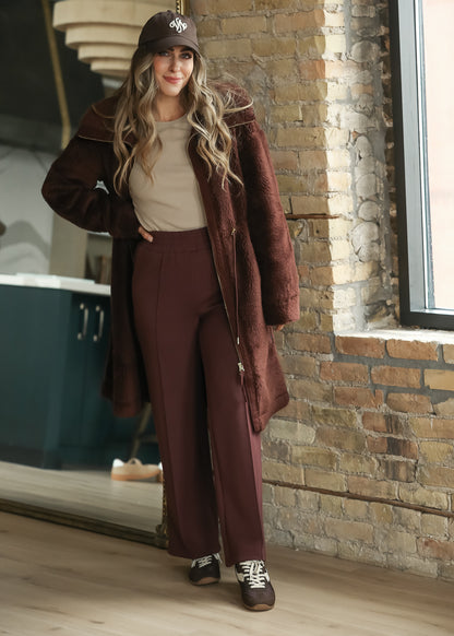 Mahogany long sherpa coat with wide collar, zip front, and knee-length silhouette.