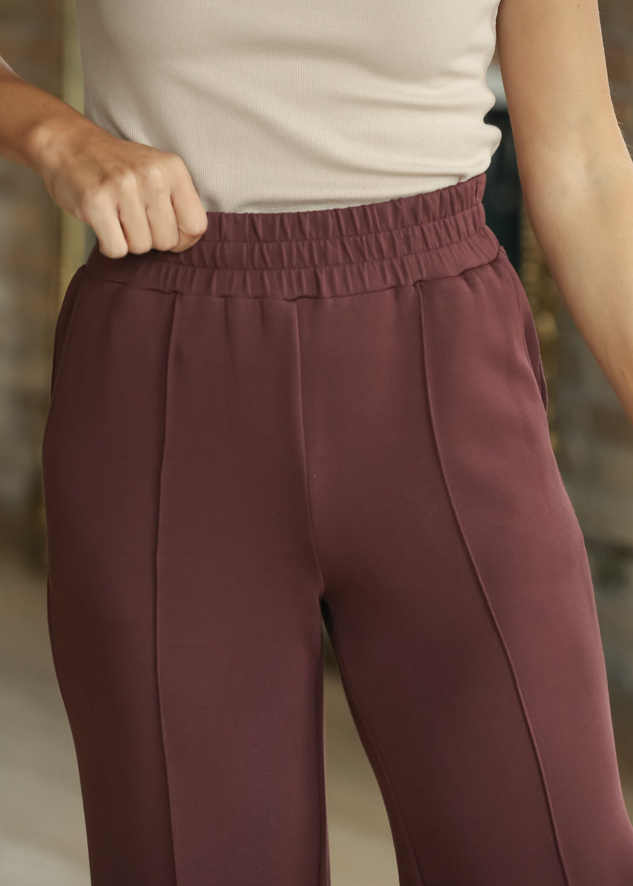 Close-up of Mahogany wide-leg pants with elastic waistband and front seam detail
