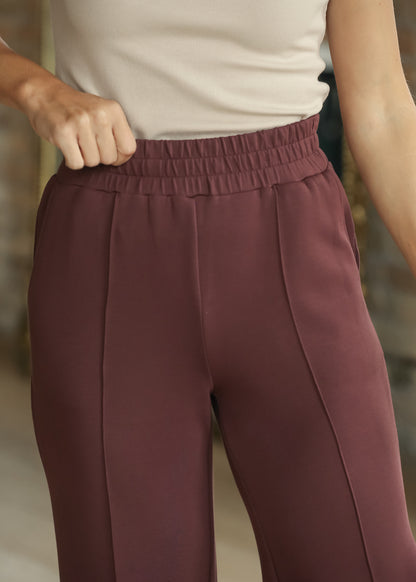 Close-up of Mahogany wide-leg pants with elastic waistband and front seam detail