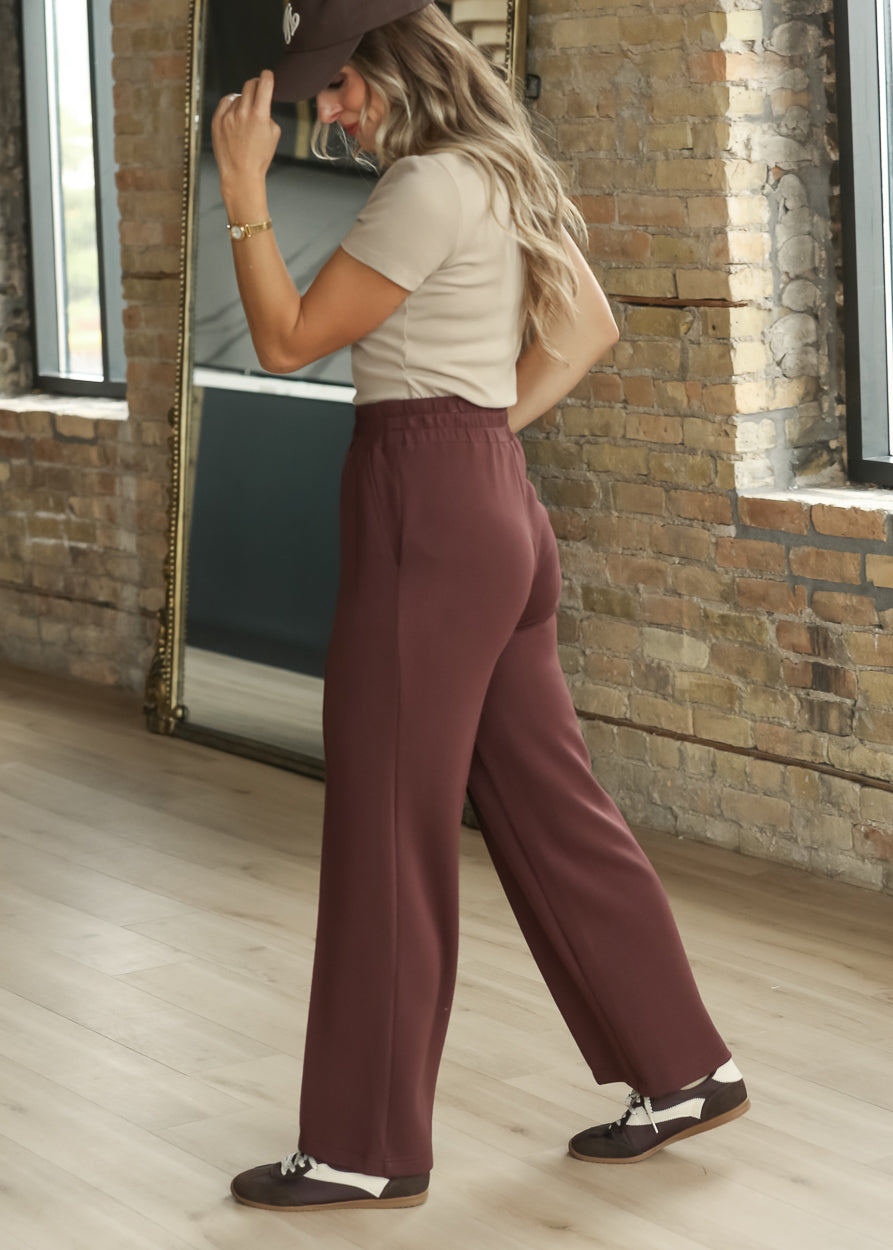 Side view of Varley Mahogany wide-leg pants with smooth drape through the leg
