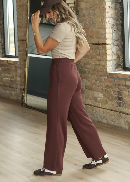 Side view of Varley Mahogany wide-leg pants with smooth drape through the leg