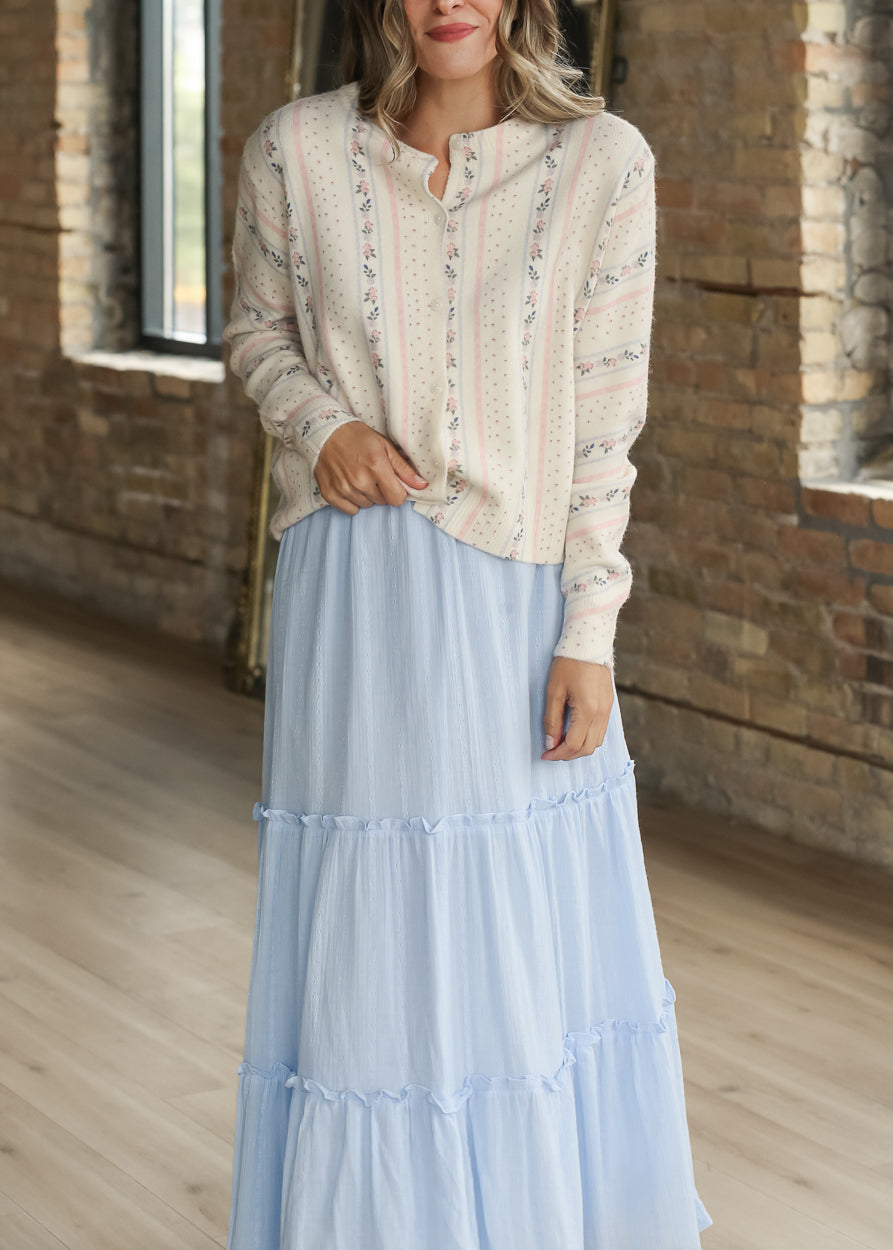 Cream floral stripe cardigan styled with a light blue tiered maxi skirt.