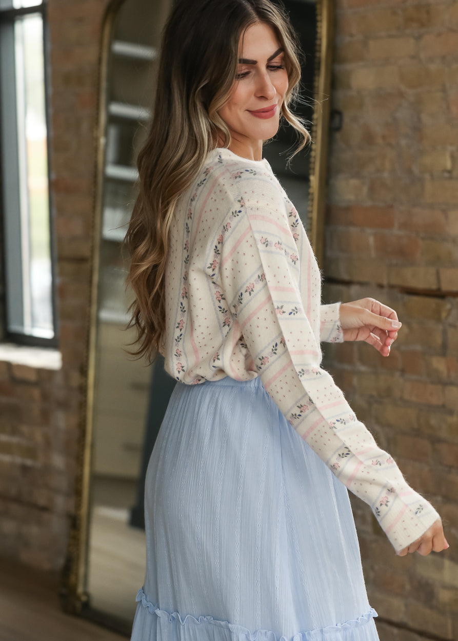 Side view of cream floral stripe cardigan with long sleeves and soft vintage-inspired pattern.