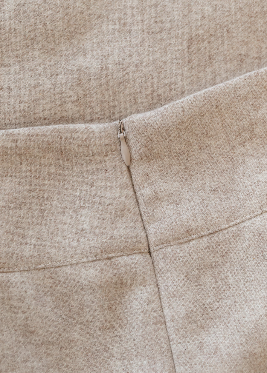 Close-up of the oatmeal wool blend fabric and back zipper construction on the Wanda midi skirt.