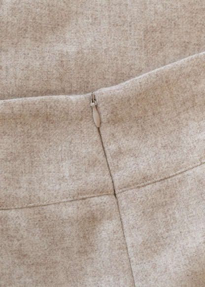 Close-up of the oatmeal wool blend fabric and back zipper construction on the Wanda midi skirt.
