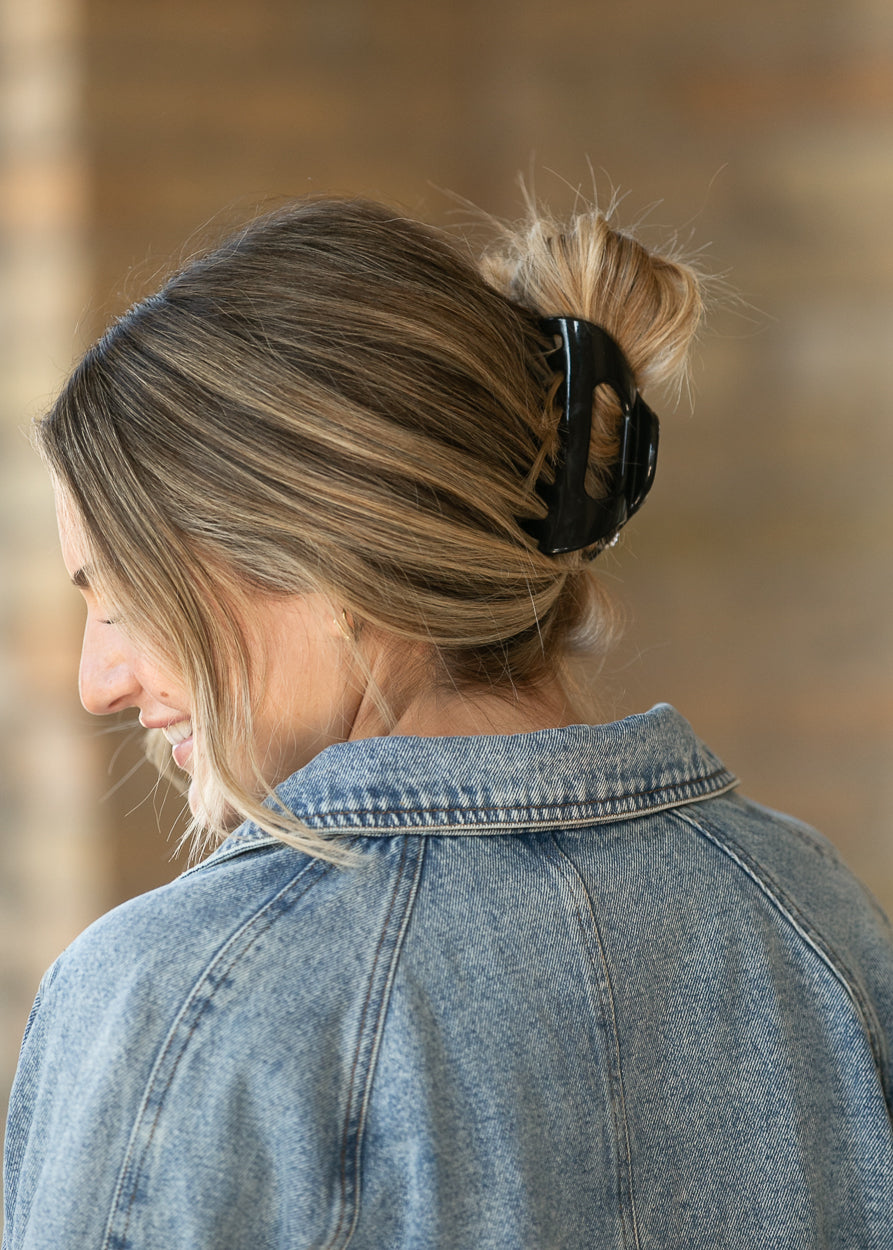 Close-up of back collar and seam details on the light wash cropped denim jacket.